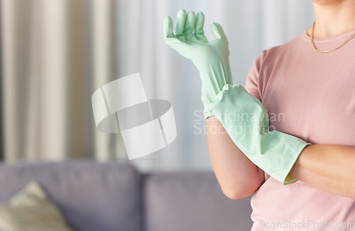 Image of Woman, hands and gloves in housekeeping preparation for cleaning, dirt removal or disinfection in living room at home. Hand of cleaner ready to start spring clean service for safety with rubber glove