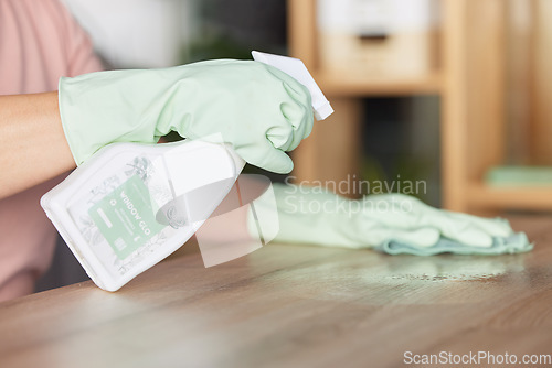 Image of Woman, hands and cleaning table in housekeeping for bacteria or germ removal at home. Hand of female cleaner wiping surface with spray bottle and cloth for clean hygiene and furniture disinfection