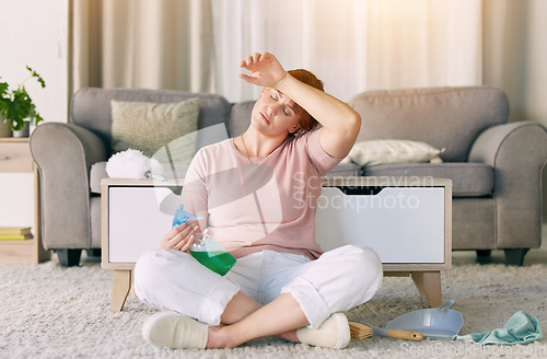 Image of Tired woman, housekeeping and detergent from spring cleaning services in living room on floor at home. Exhausted female maid or cleaner in burnout, stress or fatigue for routine maintenance in lounge