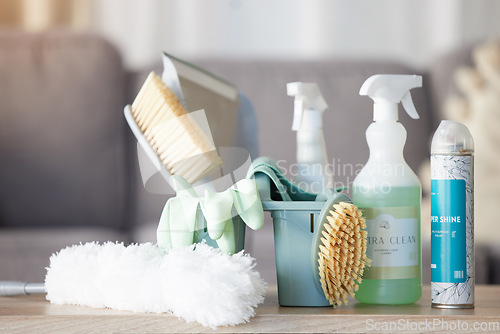 Image of Cleaning equipment, detergent and tools on table for housekeeping, clean supplies or service in living room at home. Hygiene products on counter for sanitizing, washing or disinfection services