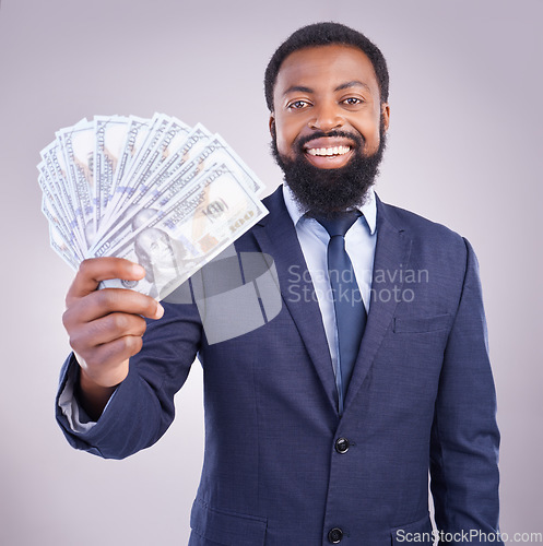 Image of Portrait, money and investment with a business black man in studio on a gray background as a lottery winner. Cash, accounting and finance with a male employee holding dollar bills for the economy