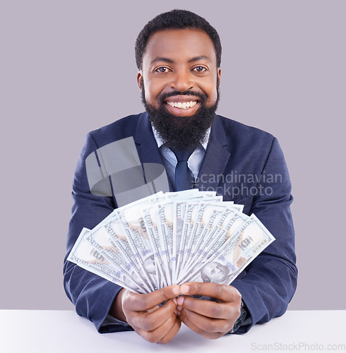 Image of Portrait, cash and investment with a business black man in studio on a gray background as a lottery winner. Money, accounting and finance with a male employee holding dollar bills for the economy