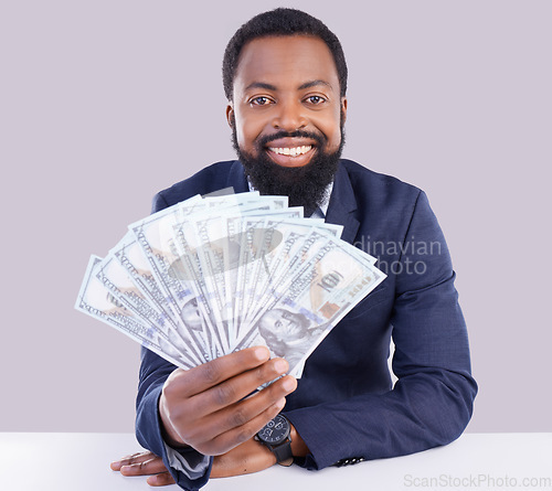 Image of Portrait, cash and economy with a business black man in studio on a gray background as a lottery winner. Money, accounting and finance with a male employee holding dollar bills for investment