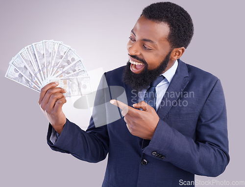Image of Wow, money and investment with a business black man in studio on a gray background as a lottery winner. Cash, accounting and finance with a male employee pointing to dollar bills for the economy