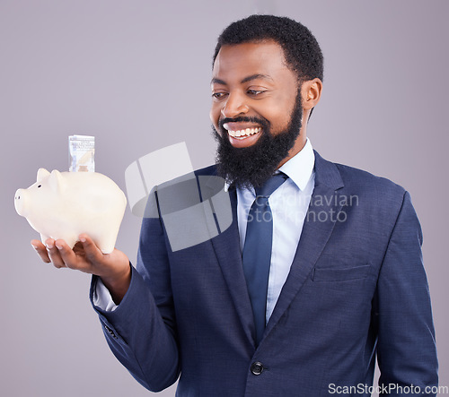 Image of Black man, piggy bank and smile for financial investment or savings against a white studio background. Happy African American businessman smiling holding cash or money pot for investing in finance