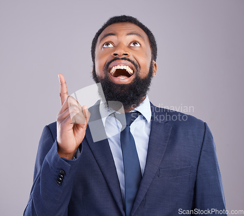 Image of Wow, pointing and promotion with a business black man in studio on a gray background for motivation. Winner, hand gesture and announcement with a corporate male employee celebrating success