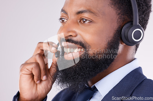 Image of Call center, smile and face of black man with microphone for crm questions, sales consulting and help. Happy male telemarketing consultant in studio for contact, telecom and friendly customer support