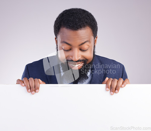 Image of Mockup, happy and a black man looking at a board isolated on a white background in a studio. Smile, banner and an African businessman with a poste, reading space and showing a commercial message