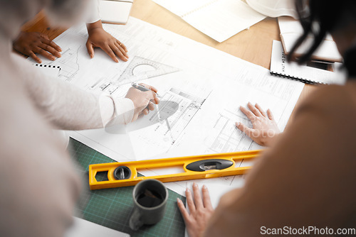 Image of Hands, collaboration and construction with a building team working in their office on design from above. Teamwork, architecture or blueprint with an architect, designer and engineer at work together