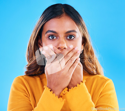 Image of Shock, surprise and portrait of a woman in a studio with a omg, wtf or wow face expression. Amazed, shocked and female model posing with a surprised reaction to news isolated by a blue background.