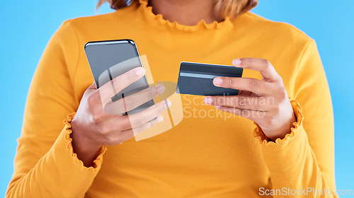 Image of Woman hands, credit card and phone in studio for online shopping, digital fintech payment and customer money. Closeup female, ecommerce and mobile banking for finance, cash economy or sales promotion