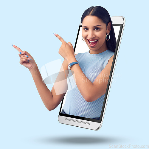 Image of Woman, phone and screen on mockup pointing for product placement against studio background. Portrait of happy female showing finger gesture or point for marketing or advertising on smartphone display