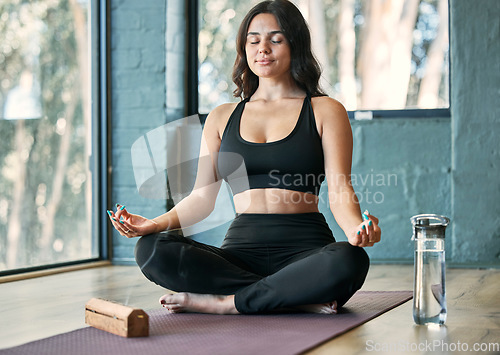 Image of Yoga, lotus meditation and woman in gym for health, wellness and mindfulness exercise. Pilates, zen chakra and calm female yogi meditate for spiritual training, holistic workout or peace with incense