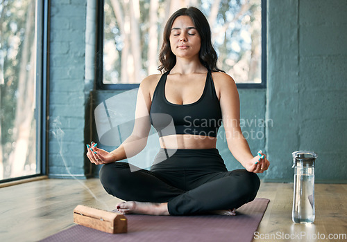 Image of Yoga, lotus meditation and woman in gym for health, wellness and mindfulness exercise. Pilates, zen chakra and calm female yogi meditate for spiritual training, holistic workout or peace with incense