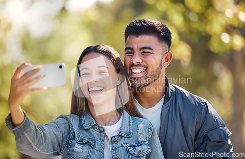 Image of Couple, outdoor and selfie with a smile for love, care and happiness together in summer. Young man and woman at nature park for a profile picture on a happy and romantic date or vacation to relax