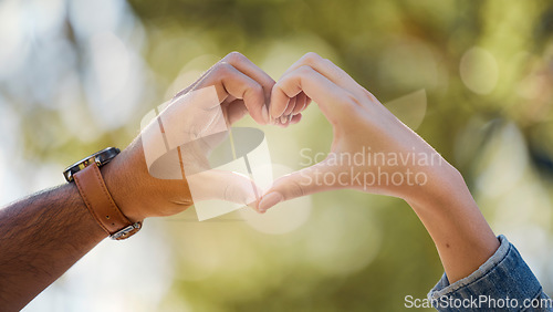 Image of Couple, heart and hands in park of love, date or marriage commitment together in garden. Closeup man, woman and finger shape of care in relationship, support and trust of hope, freedom and emoji sign