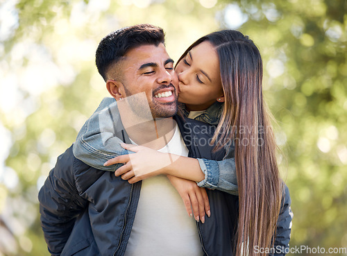 Image of Couple, outdoor and piggyback with kiss for love, care and happiness together in summer. Young man and woman at nature park for affection, play or game on happy and romantic date or vacation to relax