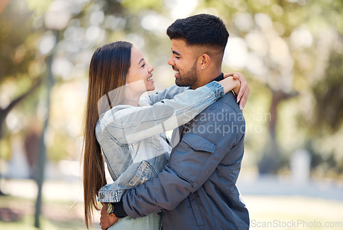 Image of Couple, hug and outdoor with a smile for love, care and happiness together in summer. Young man and woman at nature park for affection or trust on a happy and romantic date or vacation to relax