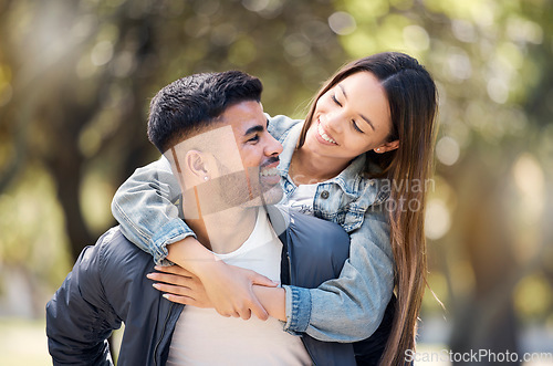 Image of Couple, smile and outdoor on piggyback for love, care and happiness together in summer. Young man and woman at nature park for a moment on a happy and romantic date or vacation to relax