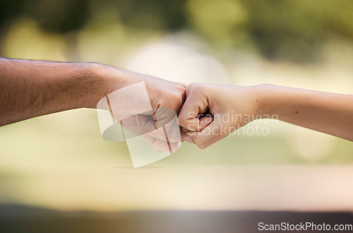 Image of Teamwork, fist bump and people with outdoor support, collaboration and team building mission or agreement. Man, woman partner or couple of friends with deal, challenge or power hands sign in a park