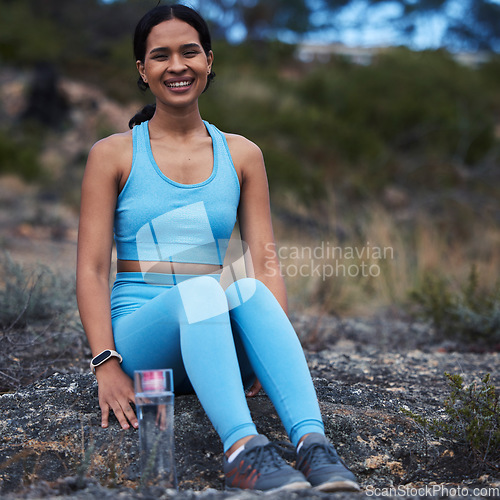 Image of Woman, portrait or fitness break in nature training, exercise or workout for cardio, wellness or athlete sports. Smile, happy or relax runner sitting in remote park for outdoor marathon running