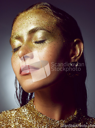 Image of Gold, woman luxury and beauty sparkle of a female with makeup and cosmetic glitter. Creative fashion, cosmetics and face glow of a young person with eyeshadow shimmer and golden sparkles in studio