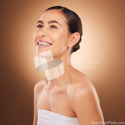 Image of Studio face, happy and beauty woman with luxury facial cosmetics, natural makeup and skincare glow. Dermatology healthcare satisfaction, spa salon person or aesthetic female model on brown background