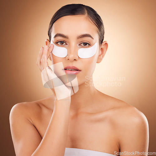 Image of Skincare, portrait or woman with eye patch for studio dermatology, face healthcare or beauty treatment. Spa care, facial collagen product or female model with hyaluronic acid mask on brown background