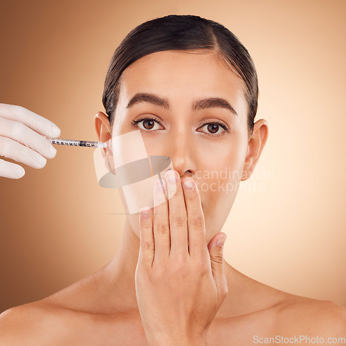 Image of Plastic surgery surprise, hands or portrait woman with needle facial change, cosmetics process or studio skincare. Injection, female healthcare or face model with aesthetic beauty on brown background