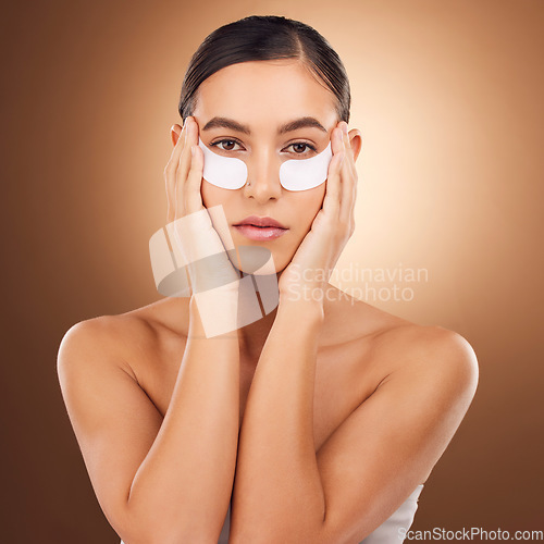 Image of Woman beauty, face portrait and eye patch for studio dermatology, spa healthcare or cosmetics routine. Skincare, facial collagen product or female model with hyaluronic acid mask on brown background