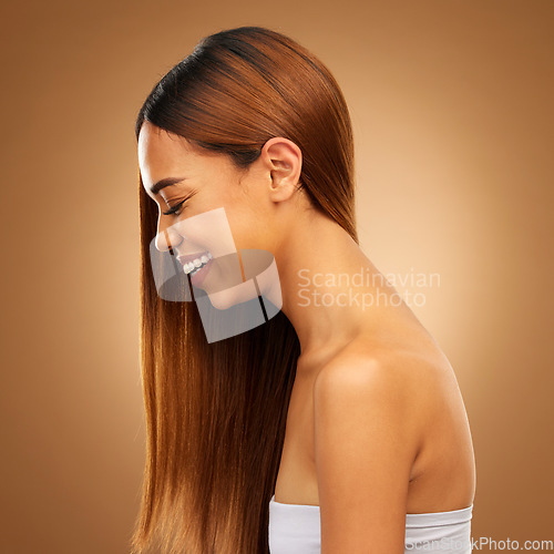 Image of Haircare, beauty and woman of laughing in studio for growth and color shine or healthy texture. Aesthetic female happy face for hair, natural skincare and hairdresser or salon on brown background