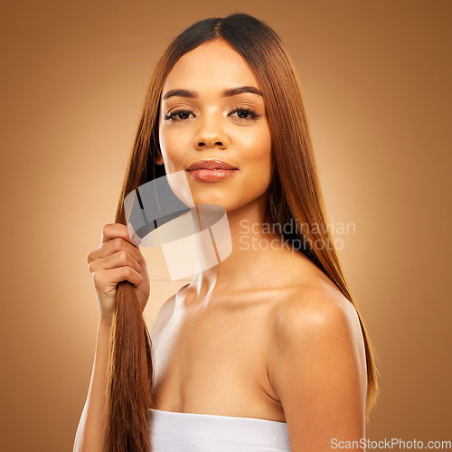 Image of Haircare, hand and strength, portrait of woman in studio holding strong hair with texture and salon shine. Happy model, mockup and beauty, straight hairstyle with keratin product on brown background.