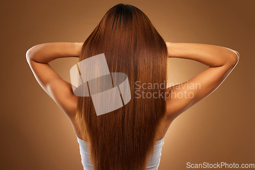 Image of Back of hair, beauty and woman in studio for growth, wellness and keratin treatment on brown background. Hairdresser mockup, salon and girl with hairstyle for shampoo, haircare texture or cosmetics