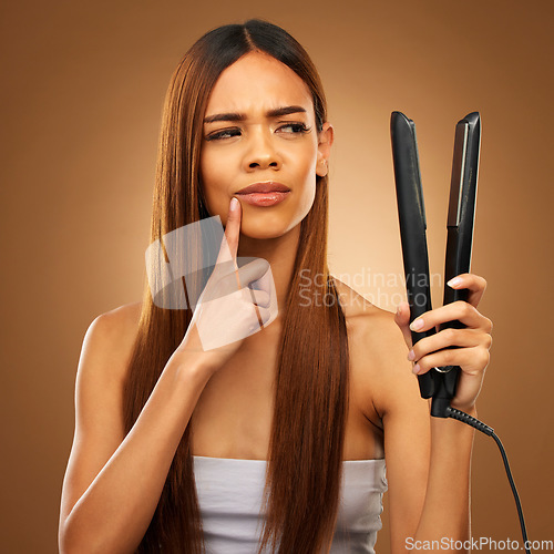 Image of Hair, thinking and woman with flat iron for beauty, wellness and keratin treatment on brown background. Hairdresser mockup, salon and confused girl for healthy growth, haircare texture and cosmetics