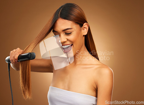 Image of Hair, flat iron and woman with smile in studio for beauty, wellness and keratin treatment on brown background. Hairdresser mockup, salon and girl hairstyle for heat, haircare texture and cosmetics