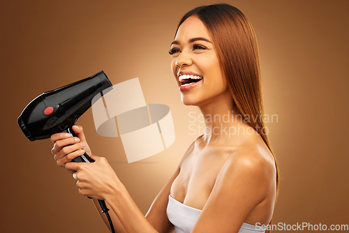 Image of Hairdryer, beauty tools and happy woman with hair care, face and blow drying on brown background. Cosmetics, equipment and keratin treatment with mockup, female with smile in studio and shine