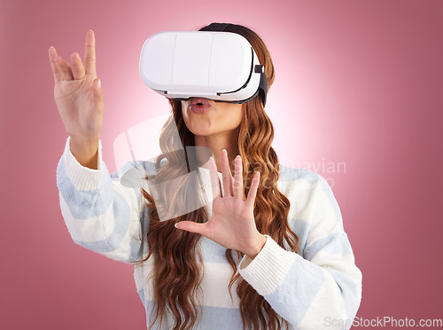 Image of Virtual reality, metaverse and gaming with a woman using a headset to access the virtual world of innovation. AI, 3D and VR with a female gamer in studio on a pink background using future technology