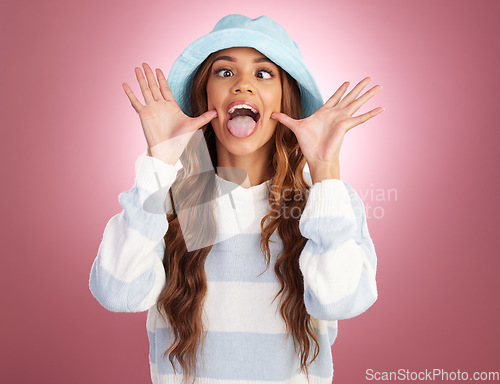 Image of Fashion, comic hands and face of woman on studio background for funny, humour and emoji reaction. Beauty, facial expression and happy girl with confidence, happiness and crazy sign in trendy clothes