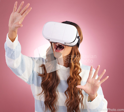 Image of Virtual reality, metaverse and 3D with a woman using a headset to access the virtual world of gaming. AI, innovation and VR with a female gamer in studio on a pink background using future technology
