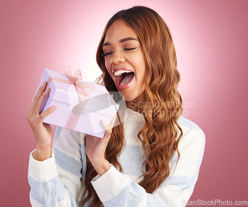 Image of Woman, gift and box in studio for thinking, happiness and surprise celebration by gradient background. Student girl, young and happy with present package, excited face and celebrate birthday with wow