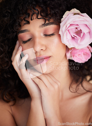 Image of Flowers, rest and face of woman with makeup, cosmetics and beauty for wellness, glamour and glow in studio. Salon aesthetic, spa and girl with closed eyes for natural, skincare and facial treatment