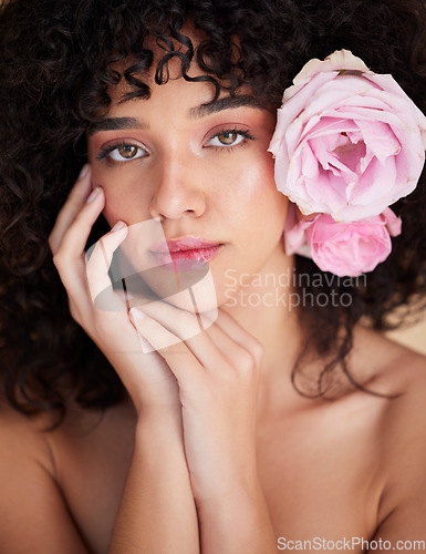 Image of Flowers, makeup and portrait of woman for beauty, cosmetics and haircare for wellness, glamour and glow. Salon, luxury spa and serious face of girl for natural, skincare or facial treatment in studio