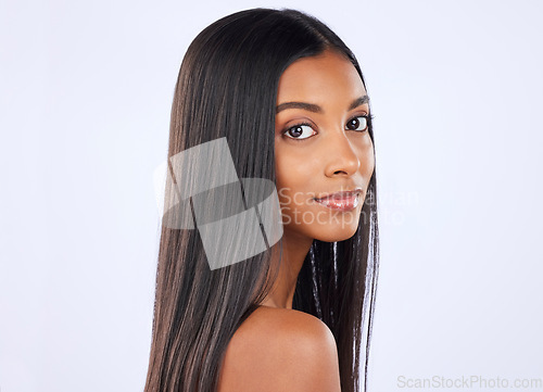 Image of Woman, portrait and straight hair in salon treatment, keratin or glow against a white studio background. Serious isolated female model in self care for healthy hairstyle, haircare or beauty cosmetics