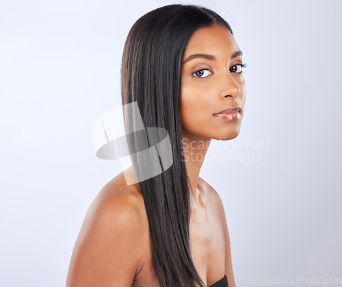 Image of Indian woman, hair care or beauty in studio portrait for strong, healthy natural shine or wellness. Face of glowing young girl model, self love or salon cosmetics in grooming on white background