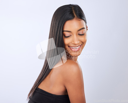 Image of Happy, hair care or Indian woman in studio for beauty, healthy natural shine, growth or wellness. Smile of glowing young girl model, self love or salon spa cosmetics in grooming on white background