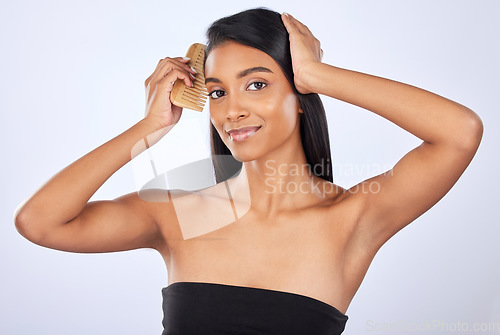 Image of Woman comb hair, beauty and haircare cosmetics, keratin treatment and smile in portrait on studio background. Indian female grooming, straight hairstyle and skin glow, Brazilian and cosmetic care