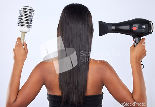 Image of Brush, hair dryer or back of woman in studio for keratin growth, healthy natural shine or wellness. Young girl model, salon spa or self care cosmetics grooming routine isolated on white background