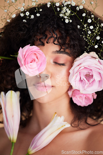Image of Beauty, flowers and face of woman relax with makeup, cosmetics and hair care for wellness, glamour and glow. Spring aesthetic, spa and girl model for natural, skincare and facial treatment in studio
