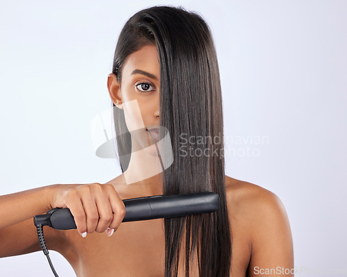 Image of Portrait, woman or hair straightener in studio for beauty self care or treatment isolated on white background. Face, Indian girl model or salon equipment for ironing in grooming routine for styling