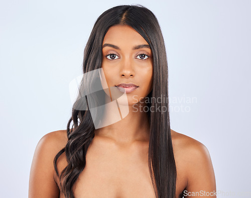 Image of Girl, hair care or beauty in studio portrait for strong, healthy natural shine or wellness on white background. Face of glowing young model, Indian woman or salon spa for curly style in grooming